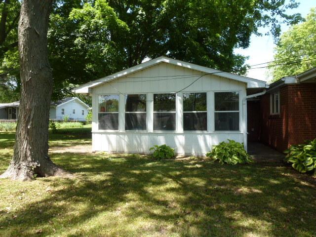 503 S Wilson St, Clinton, IL 61727 - view of side of property with a yard and a sunroom