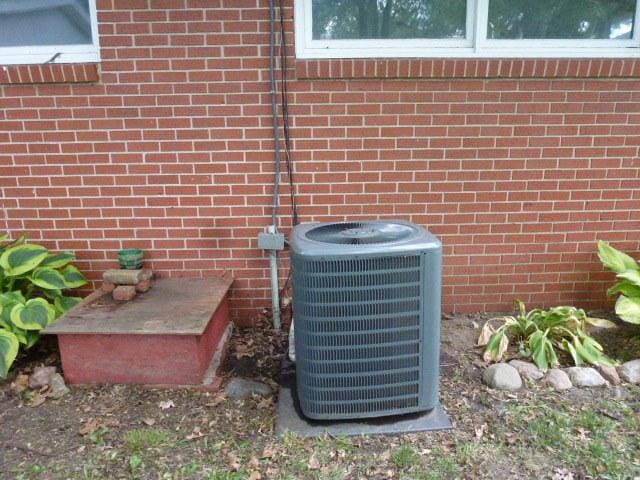 503 S Wilson St, Clinton, IL 61727 - exterior view of a central AC unit and brick siding
