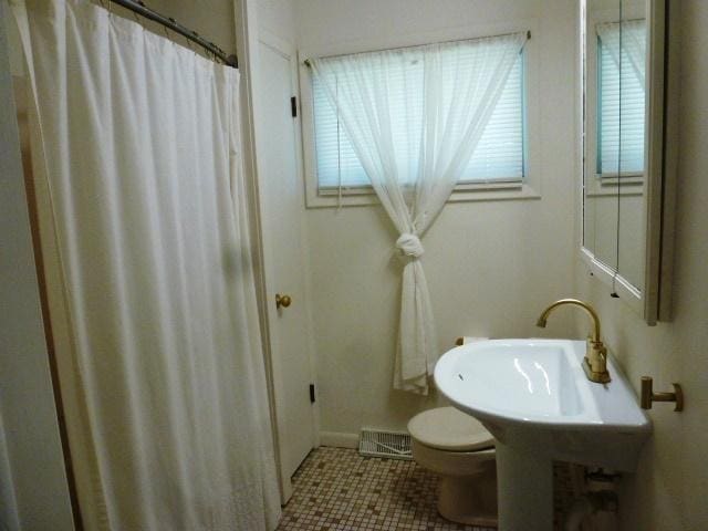 503 S Wilson St, Clinton, IL 61727 - full bathroom with tile patterned floors and a shower with shower curtain
