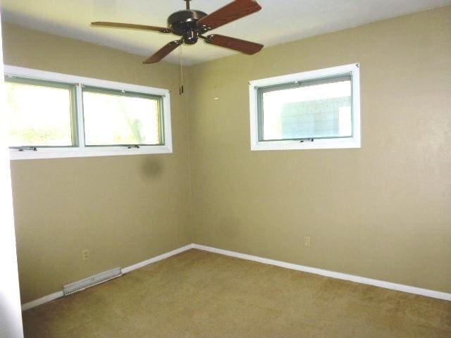 503 S Wilson St, Clinton, IL 61727 - carpeted empty room featuring a ceiling fan and baseboards