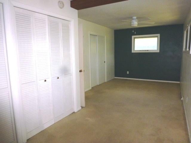 503 S Wilson St, Clinton, IL 61727 - unfurnished bedroom with carpet and a ceiling fan