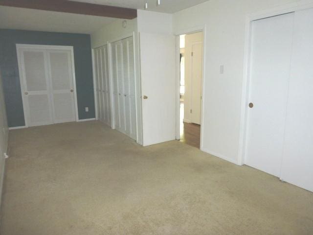 503 S Wilson St, Clinton, IL 61727 - unfurnished bedroom with carpet and multiple closets