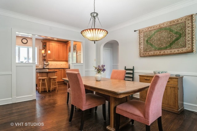 807 Fair Oaks Ave, Oak Park, IL 60302 - dining space featuring arched walkways, dark wood finished floors, and crown molding