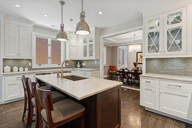 1725 N Fremont St, Chicago, IL 60614 - kitchen with recessed lighting, tasteful backsplash, dark wood-style floors, white cabinets, and a center island with sink