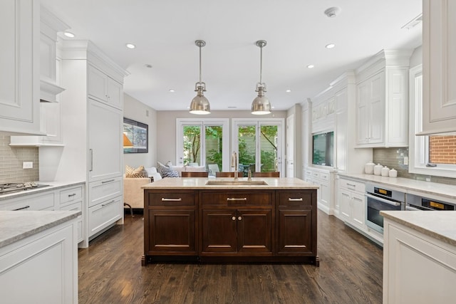 1725 N Fremont St, Chicago, IL 60614 - kitchen featuring dark wood-style flooring, white cabinetry, dark brown cabinetry, recessed lighting, and stovetop