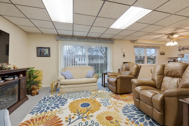 57 Brantwood Ave, Elk Grove Village, IL 60007 - living room featuring a glass covered fireplace, carpet floors, ceiling fan, and a paneled ceiling