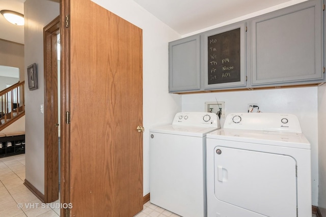 2909 Savannah Dr, Aurora, IL 60502 - laundry area with cabinet space, washer and dryer, and light tile patterned floors
