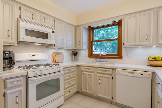 1304 W Whytecliff Rd, Palatine, IL 60067 - kitchen featuring white appliances, tasteful backsplash, tile countertops, and light tile patterned floors