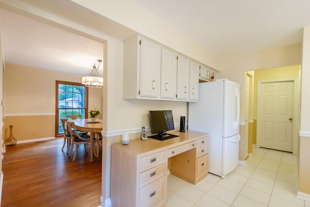 1304 W Whytecliff Rd, Palatine, IL 60067 - kitchen featuring freestanding refrigerator, built in desk, light countertops, white cabinetry, and light wood-style floors