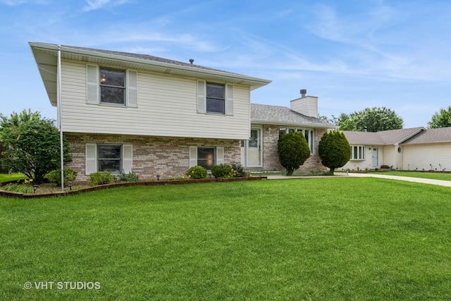 1700 Cumberland Dr, Plainfield, IL 60586 - split level home with a chimney, a front yard, and brick siding