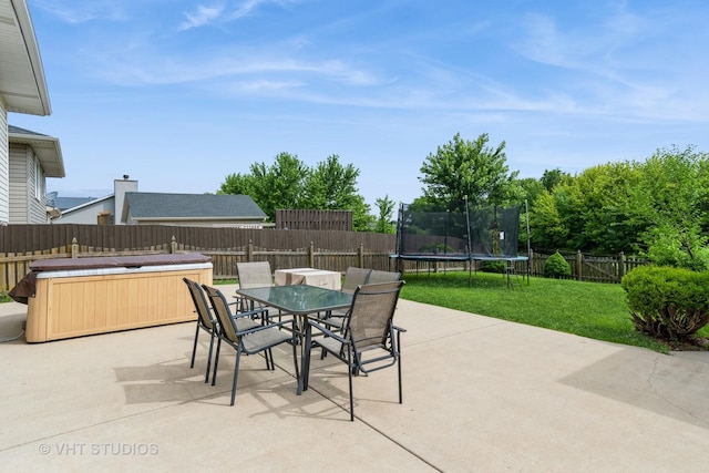 1700 Cumberland Dr, Plainfield, IL 60586 - fenced backyard featuring a hot tub, a patio, a trampoline, and outdoor dining space