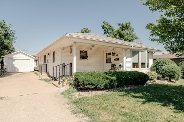 415 Swift Ave, Oglesby, IL 61348 - view of front of home featuring an outdoor structure, a front lawn, concrete driveway, and a garage