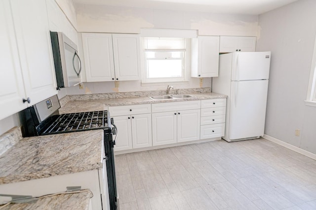 415 Swift Ave, Oglesby, IL 61348 - kitchen featuring stainless steel appliances, white cabinetry, and light wood-style flooring