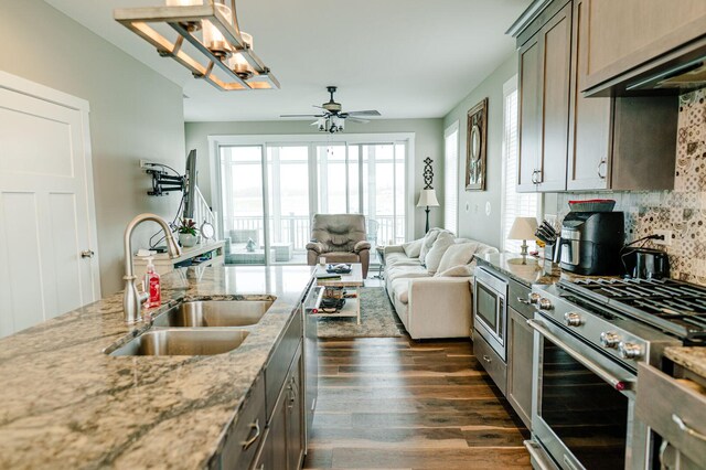 210 Leeward Way, Ottawa, IL 61350 - kitchen featuring appliances with stainless steel finishes, extractor fan, dark wood-style floors, decorative backsplash, and plenty of natural light