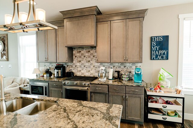 210 Leeward Way, Ottawa, IL 61350 - kitchen with appliances with stainless steel finishes, backsplash, dark wood-style flooring, and plenty of natural light