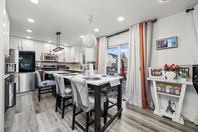 1024 Birchwood Dr, Pingree Grove, IL 60140 - kitchen with appliances with stainless steel finishes, light wood-type flooring, white cabinetry, backsplash, and recessed lighting