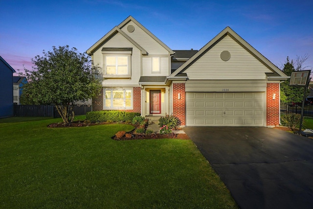 1024 Birchwood Dr, Pingree Grove, IL 60140 - traditional-style house featuring asphalt driveway, brick siding, and a garage