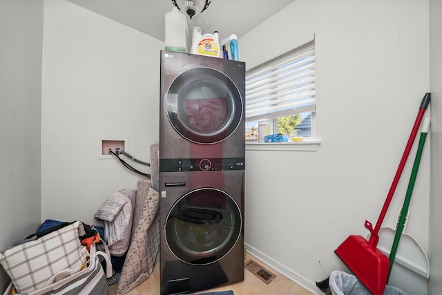 1024 Birchwood Dr, Pingree Grove, IL 60140 - laundry room featuring stacked washer / dryer and baseboards