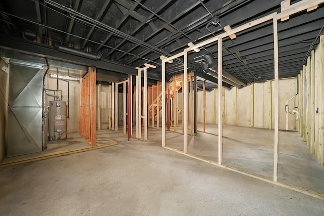 1024 Birchwood Dr, Pingree Grove, IL 60140 - unfinished below grade area featuring secured water heater, heating unit, and stairs