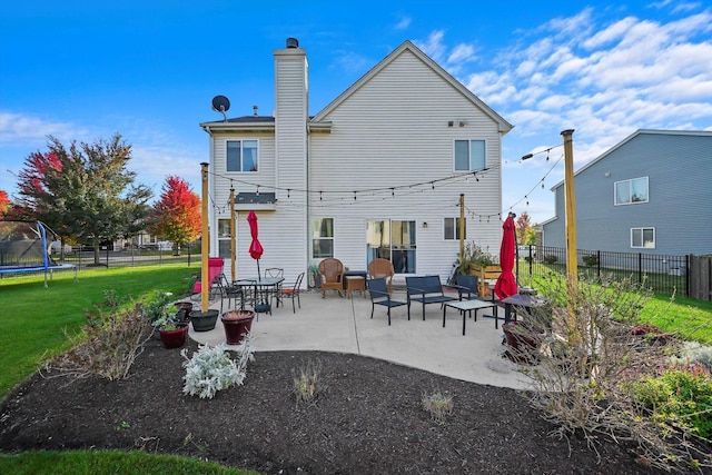 1024 Birchwood Dr, Pingree Grove, IL 60140 - back of property with a trampoline, a patio area, a fenced backyard, a chimney, and outdoor lounge area