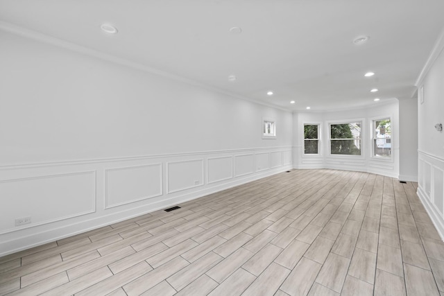 3002 Wesley Ave, Berwyn, IL 60402 - unfurnished room featuring a decorative wall, crown molding, recessed lighting, and a wainscoted wall