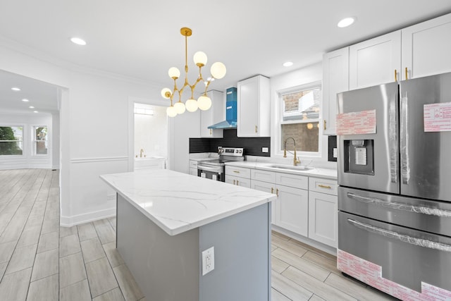 3002 Wesley Ave, Berwyn, IL 60402 - kitchen with appliances with stainless steel finishes, a center island, white cabinetry, light stone counters, and recessed lighting