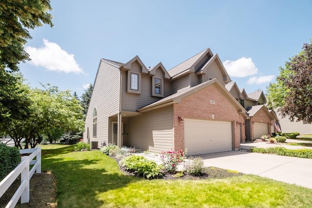 2001 Jeffrey Ln, Elgin, IL 60123 - view of front of home featuring an attached garage, a front yard, brick siding, and concrete driveway