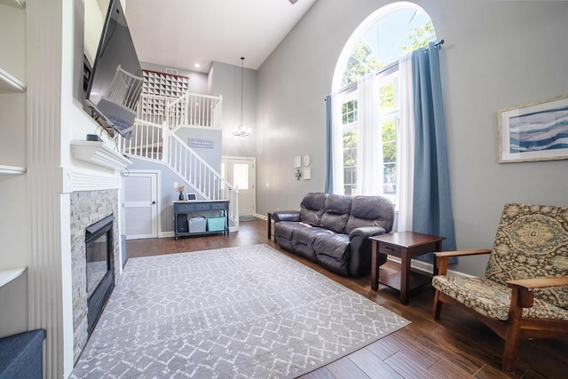 2001 Jeffrey Ln, Elgin, IL 60123 - living area with high vaulted ceiling, stairway, wood finished floors, and a glass covered fireplace