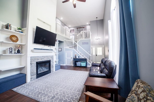 2001 Jeffrey Ln, Elgin, IL 60123 - living room with stairway, dark wood-style floors, ceiling fan, a towering ceiling, and a fireplace
