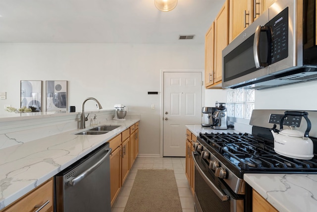 1255 N Orleans Ct Unit 1104, Chicago, IL 60610 - kitchen featuring appliances with stainless steel finishes, light tile patterned flooring, and light stone countertops