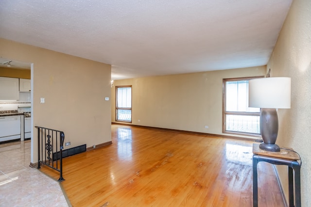 15407 Sunset Dr, Dolton, IL 60419 - unfurnished living room featuring healthy amount of natural light and light wood-style floors
