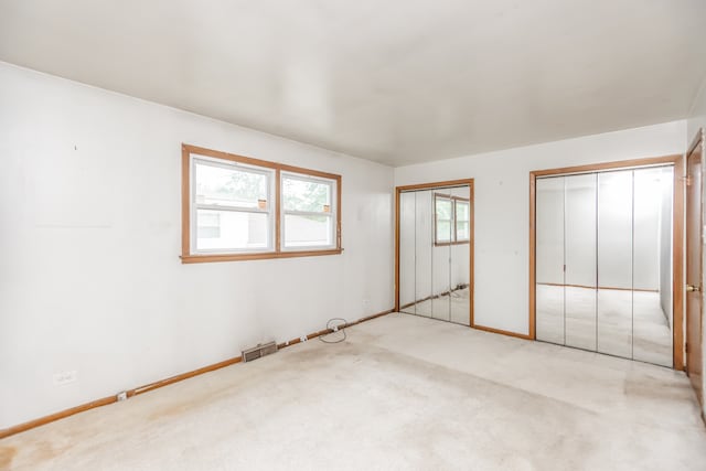 15407 Sunset Dr, Dolton, IL 60419 - unfurnished bedroom featuring two closets and carpet flooring