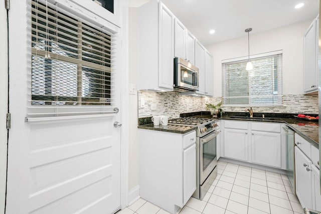 535 W Eugenie St Unit 1, Chicago, IL 60614 - kitchen featuring stainless steel appliances, backsplash, decorative light fixtures, recessed lighting, and light tile patterned floors