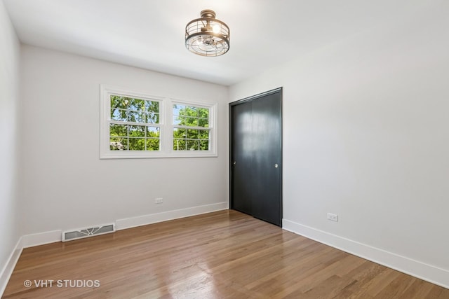 1575 Burning Trl, Wheaton, IL 60189 - unfurnished room with light wood-style flooring and a chandelier
