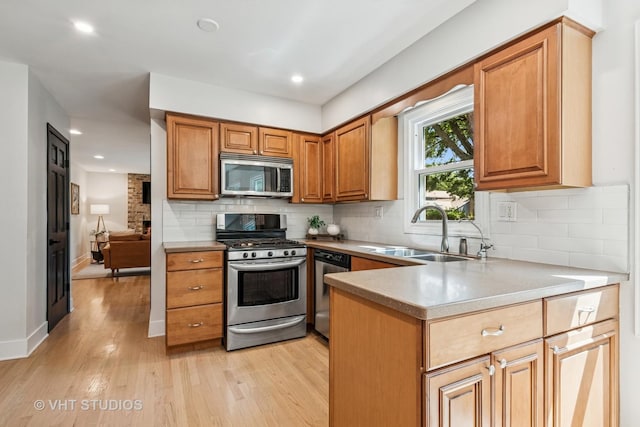 1575 Burning Trl, Wheaton, IL 60189 - kitchen featuring appliances with stainless steel finishes, light wood finished floors, backsplash, light countertops, and brown cabinets
