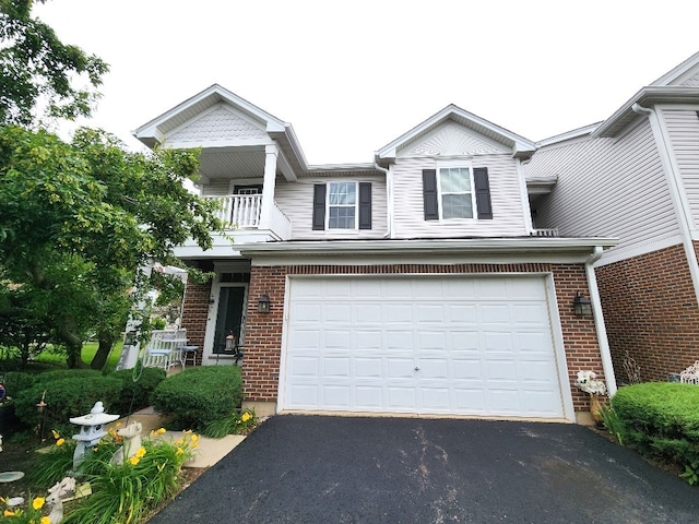 2510 Lorraine Cir, Geneva, IL 60134 - view of front facade featuring asphalt driveway, an attached garage, brick siding, and a balcony