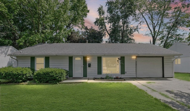 2009 E Michigan Ave, Urbana, IL 61802 - ranch-style house with an attached garage, concrete driveway, a front yard, and a shingled roof