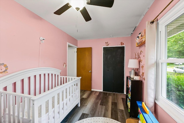 2009 E Michigan Ave, Urbana, IL 61802 - bedroom featuring wood finished floors, a crib, and a ceiling fan