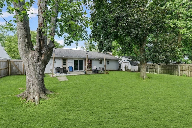 2009 E Michigan Ave, Urbana, IL 61802 - back of house with a storage shed, a patio area, a fenced backyard, and a chimney