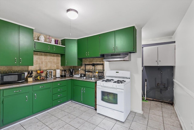 2009 E Michigan Ave, Urbana, IL 61802 - kitchen with gas range gas stove, black microwave, under cabinet range hood, decorative backsplash, and light tile patterned floors