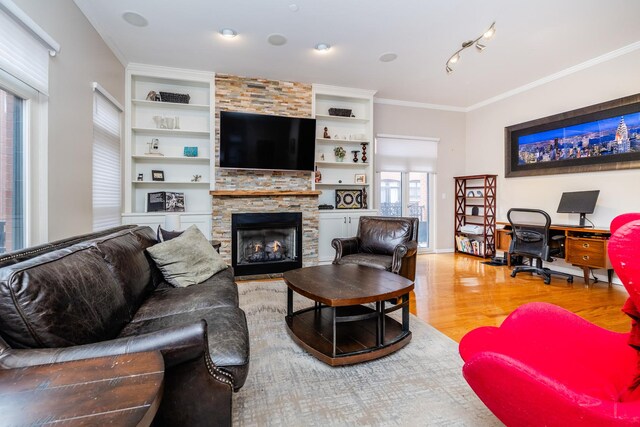909 W Village Ct, Chicago, IL 60608 - living area featuring wood finished floors, built in features, a stone fireplace, and ornamental molding