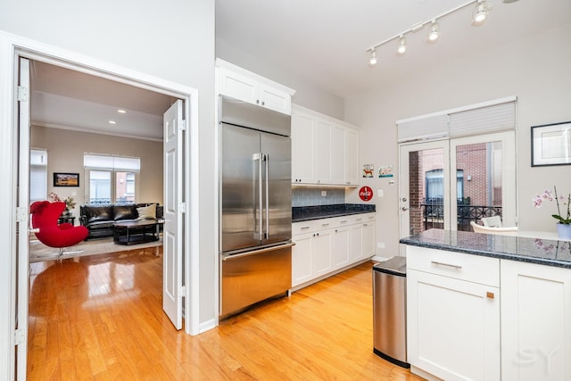 909 W Village Ct, Chicago, IL 60608 - kitchen with built in refrigerator, white cabinets, light wood-style flooring, decorative backsplash, and crown molding