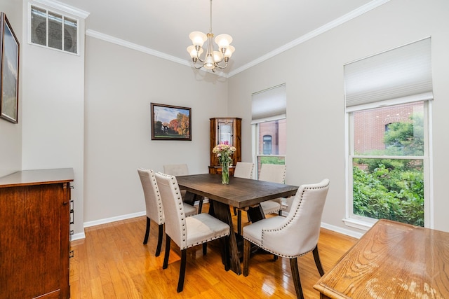909 W Village Ct, Chicago, IL 60608 - dining space with a chandelier, light wood-style floors, ornamental molding, and healthy amount of natural light
