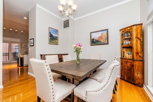909 W Village Ct, Chicago, IL 60608 - dining room featuring a chandelier, light wood-style flooring, crown molding, and recessed lighting