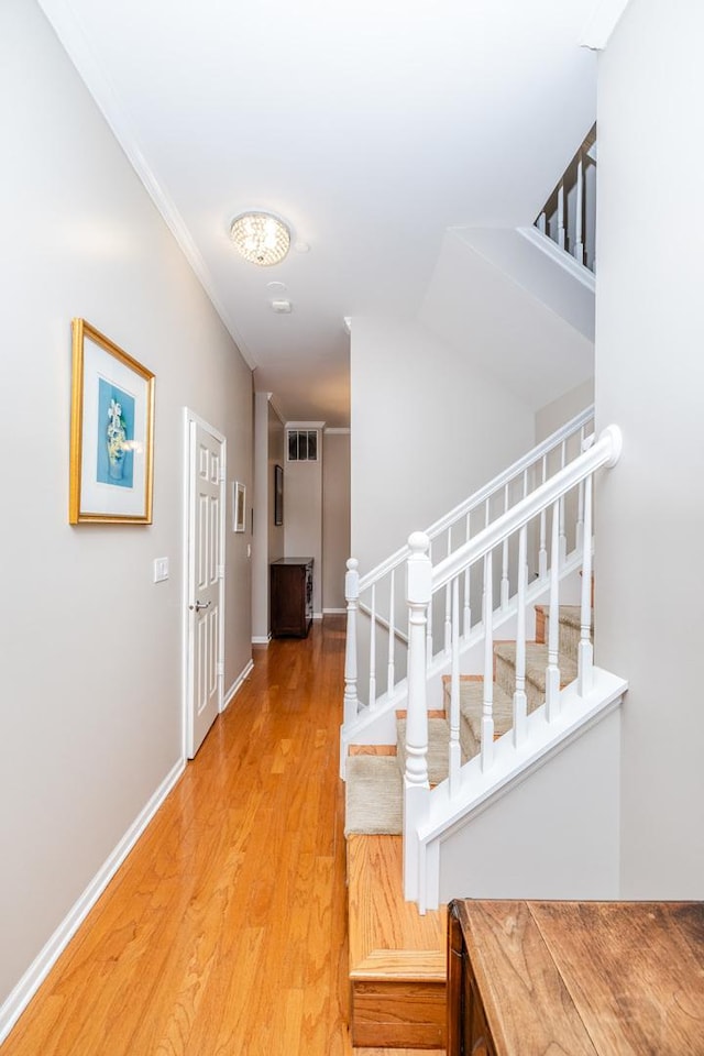 909 W Village Ct, Chicago, IL 60608 - corridor with stairs, light wood-style flooring, and crown molding