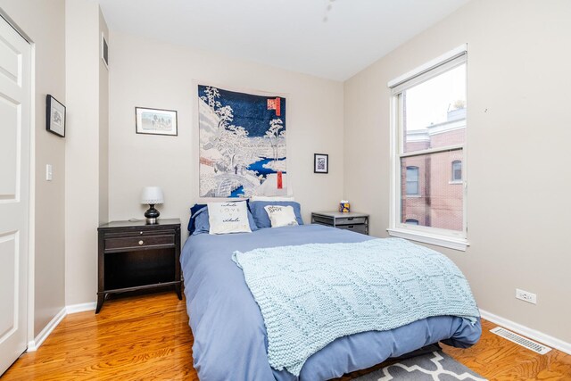 909 W Village Ct, Chicago, IL 60608 - bedroom featuring light wood-type flooring and baseboards