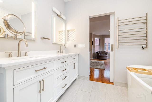 909 W Village Ct, Chicago, IL 60608 - bathroom featuring radiator, double vanity, and a freestanding tub