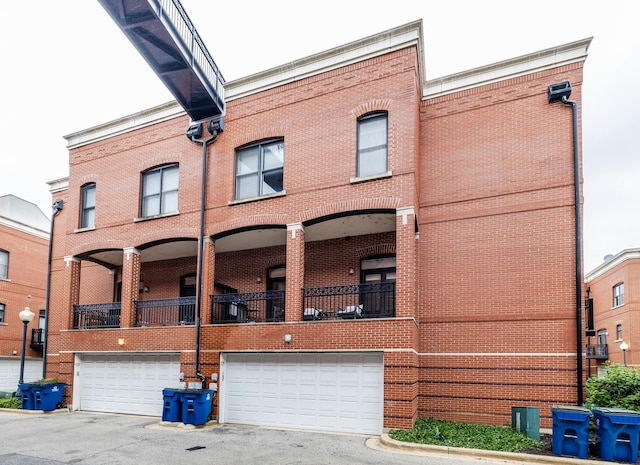 909 W Village Ct, Chicago, IL 60608 - rear view of house with brick siding, a garage, and driveway