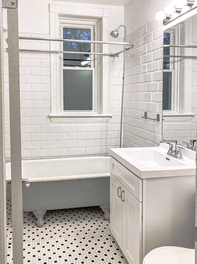 2641 W Thomas St, Chicago, IL 60622 - full bathroom featuring tile walls, vanity, and shower / bathtub combination
