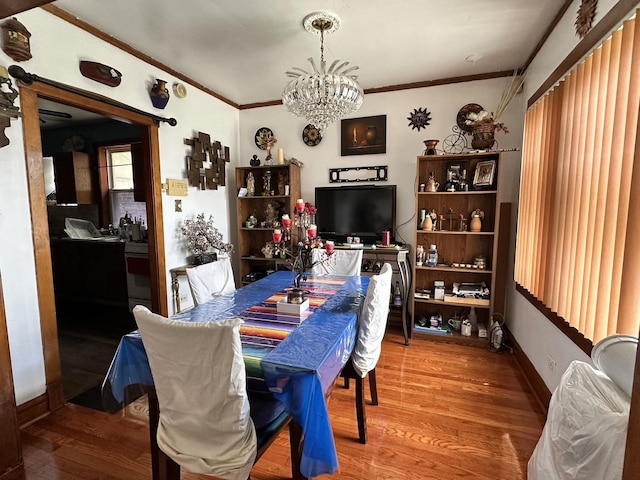 4440 W Iowa St, Chicago, IL 60651 - dining space featuring a chandelier, ornamental molding, and wood finished floors